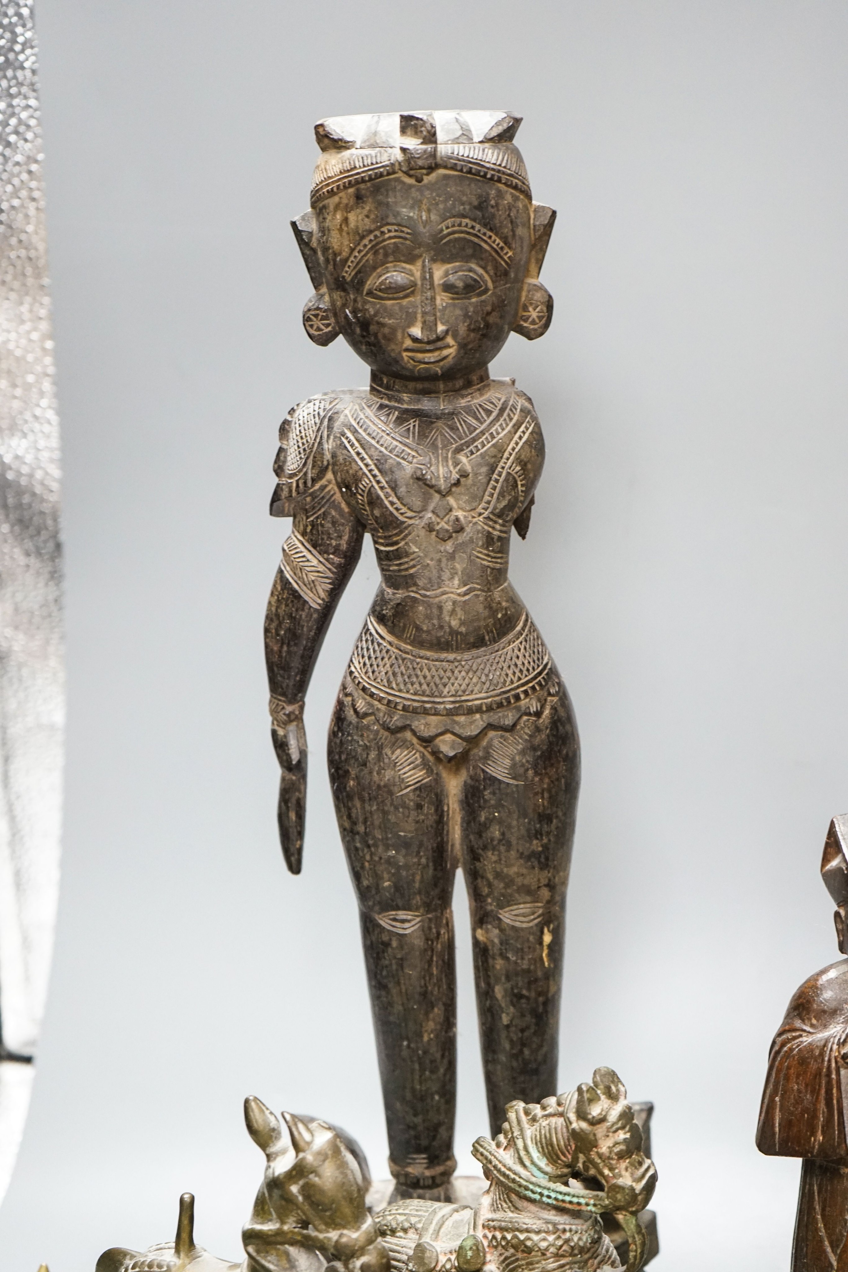 A group of Indian brass and wood figures and a Chinese wood figure